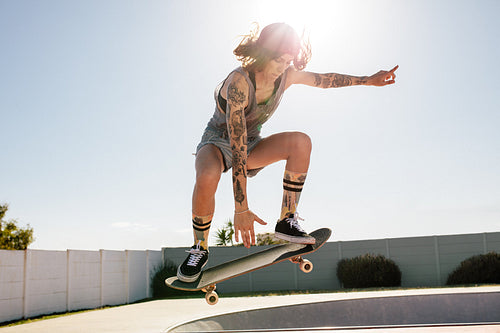Women skater doing ollie on skateboard