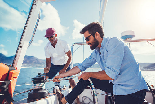 Father and son sailing on a summer day.