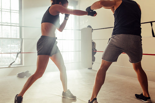 Young boxers fighting without gloves in a boxing ring