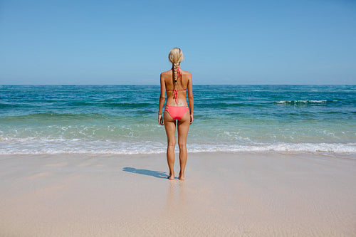 Young woman in bikini on serene beach