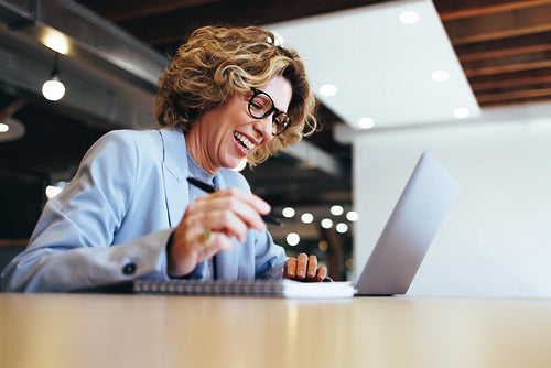 Happy business woman having a virtual meeting in an office