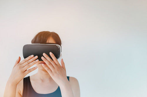 Young woman wearing virtual reality goggle