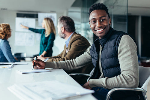 Young businessman sitting in conference room
