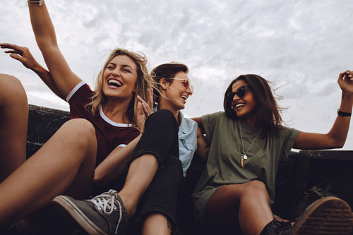Friends having fun on road trip in pickup truck
