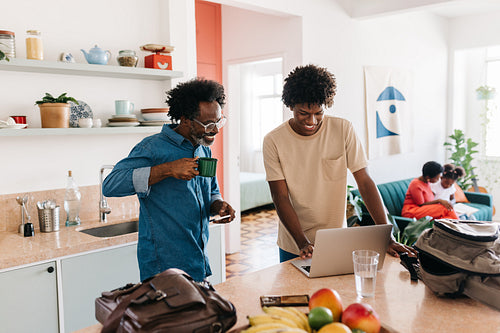 Father and son enjoying daily morning routine in the kitchen