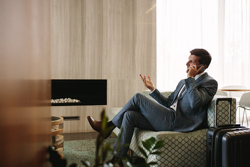 Entrepreneur at airport business lounge making phone call