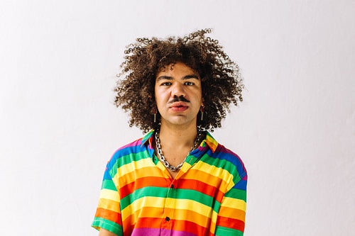 Gay man posing in a studio during pride month