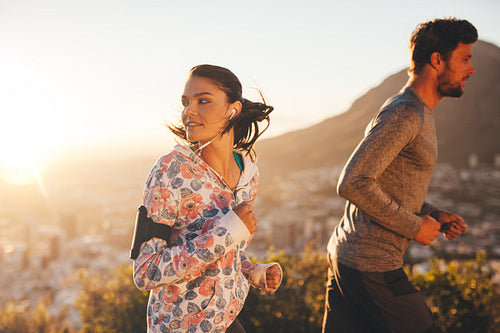 Young woman looking back while running