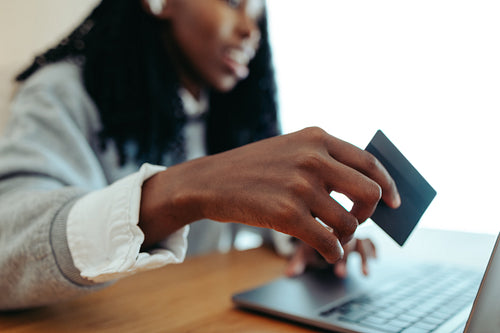Woman using bank card for online shopping