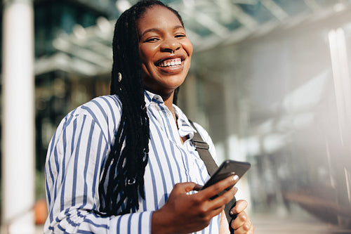 Portrait of a young black businesswoman smiling at the camera on her way to work