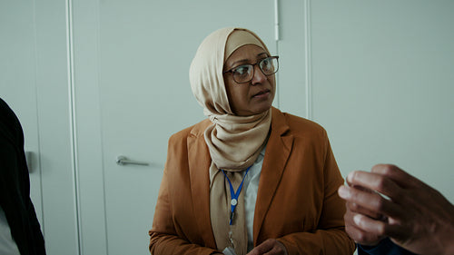 Diverse professionals engaged in a focused business meeting at a conference event