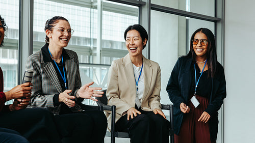 Diverse women enjoying group discussion in a bright modern office setting