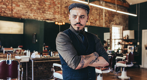 Male hairdresser standing in his shop