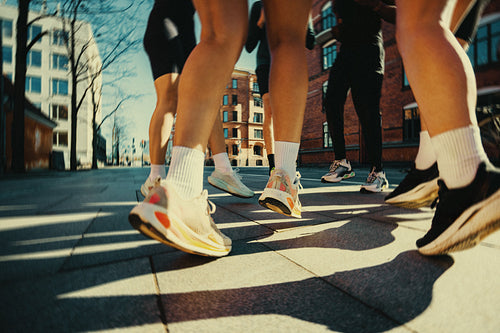 Running shoes in motion during urban city warm up on pavement