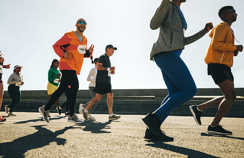 Male runner making finger guns during a community race event