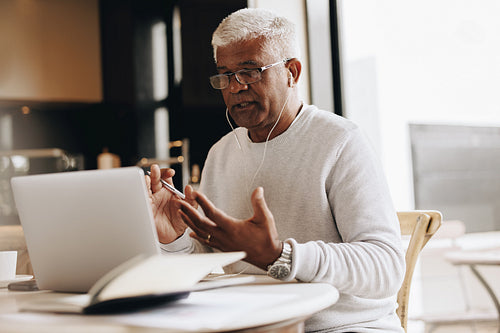 Businessman having an online meeting while working from home