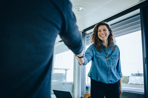 Businesswoman shaking hands with a job applicant