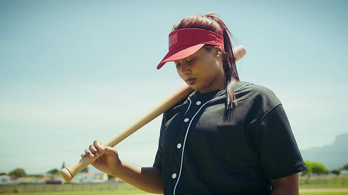 Dedicated baseball athlete holds her bat