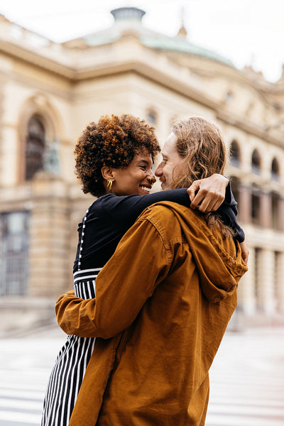 Affectionate embrace on the city streets by a diverse couple