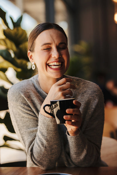 Pretty woman smiling at a coffee shop