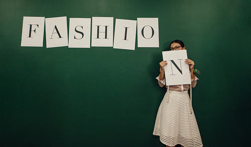 Confident young female designer in studio