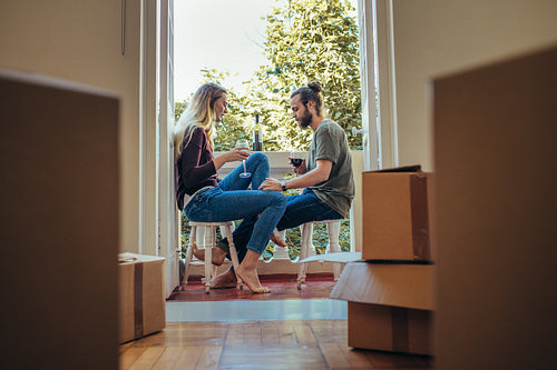 Couple enjoying a glass of wine at home