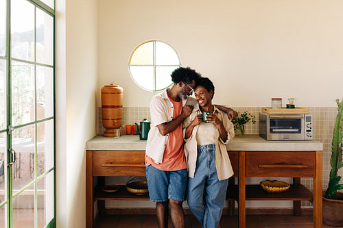 Brazilian couple being romantic in their home kitchen