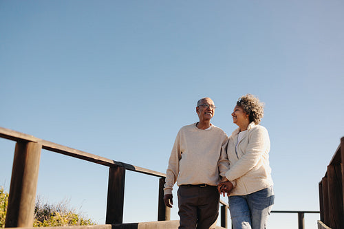 Romantic senior couple taking a walk together at the beach