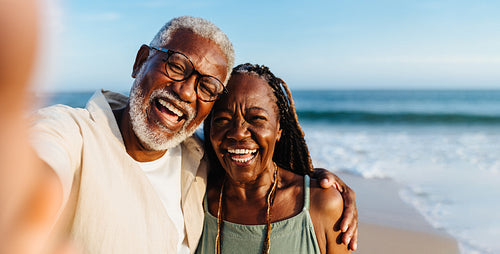 Happy senior couple sharing a joyful moment on a beach