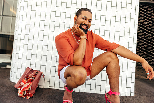 Cheerful drag queen smiling at the camera