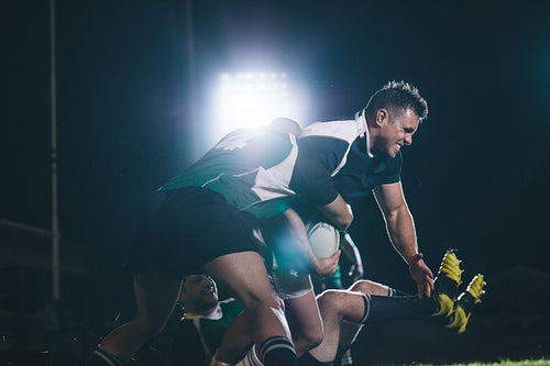 Rugby players blocking the opponent