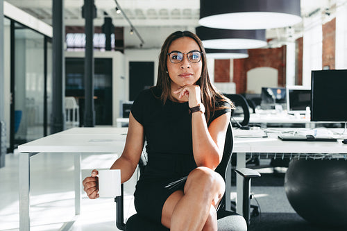 Creative businesswoman sitting in a modern office