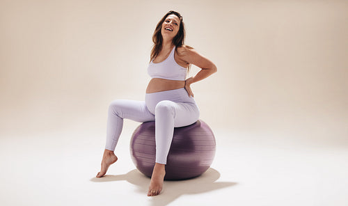 Expectant mother practicing prenatal yoga for fitness and wellness during pregnancy