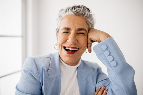 Professional and playful: Classy business woman winking in her office