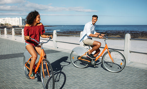 Couple riding bicycles in street