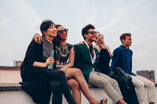 Friends hanging out together on rooftop