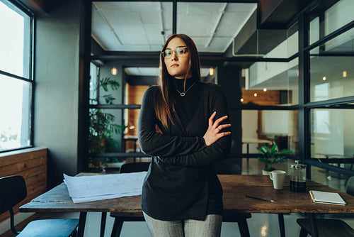 Self-confident businesswoman standing in a boardroom