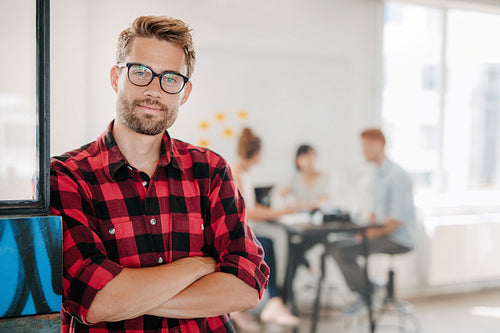 Portrait of positive businessman in office