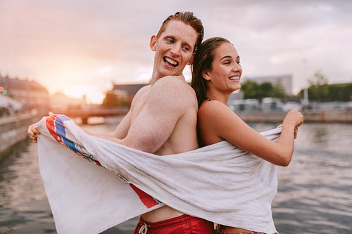 Couple wiping their body after swimming.
