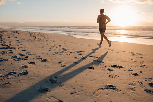 Man on morning run at the beach