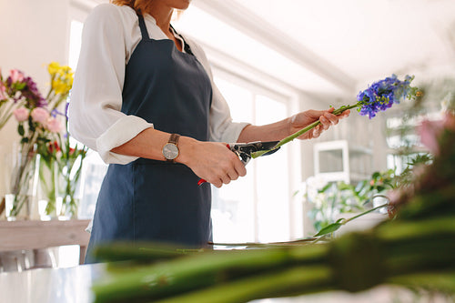 Woman creating bouquet at flower shop