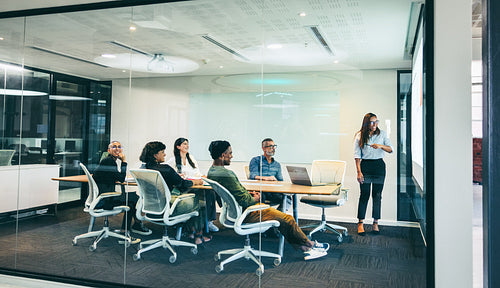 Happy businesswoman giving a financial presentation in a boardroom