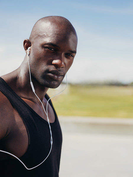 Handsome young man wearing earphones looking at camera
