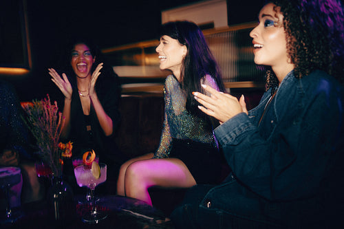 Group of young friends enjoying a night out at a stylish lounge