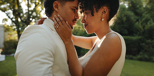 Romantic couple sharing a moment during their wedding day outdoors