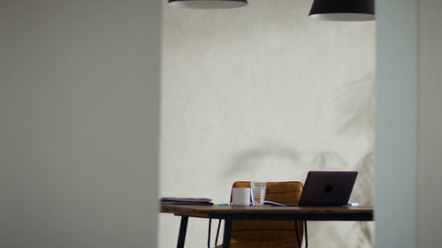 Businesswoman talks on her phone and types on her laptop in a modern office