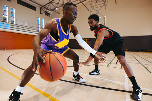 Two players competing in basketball game