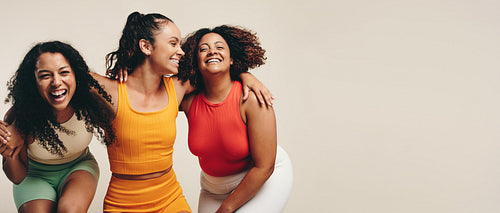 Diverse group of women in activewear smiling after workout