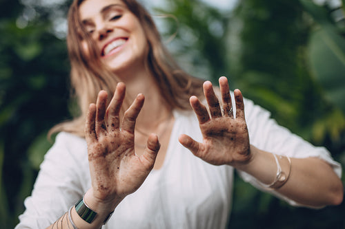 Female gardener showing her dirty hands