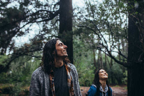 Man admiring the nature with woman at back in forest